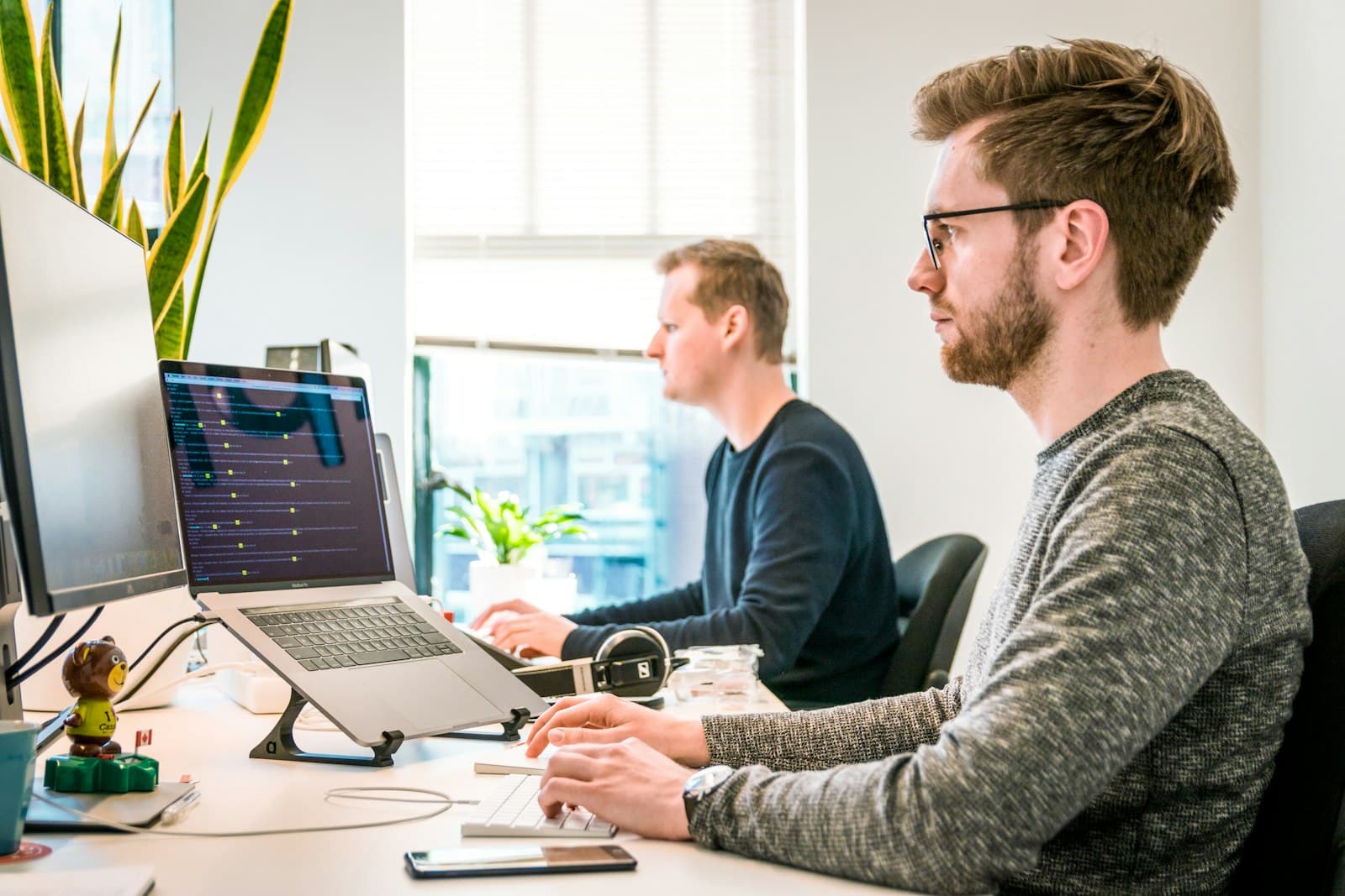 Software developers working together at their desks